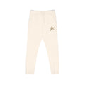 Cream-colored jogger pants with a small gold star embroidered on the left hip, shown against a plain white background.