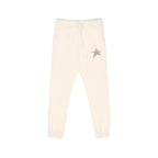 Cream-colored jogger pants with a small gold star embroidered on the left hip, shown against a plain white background.