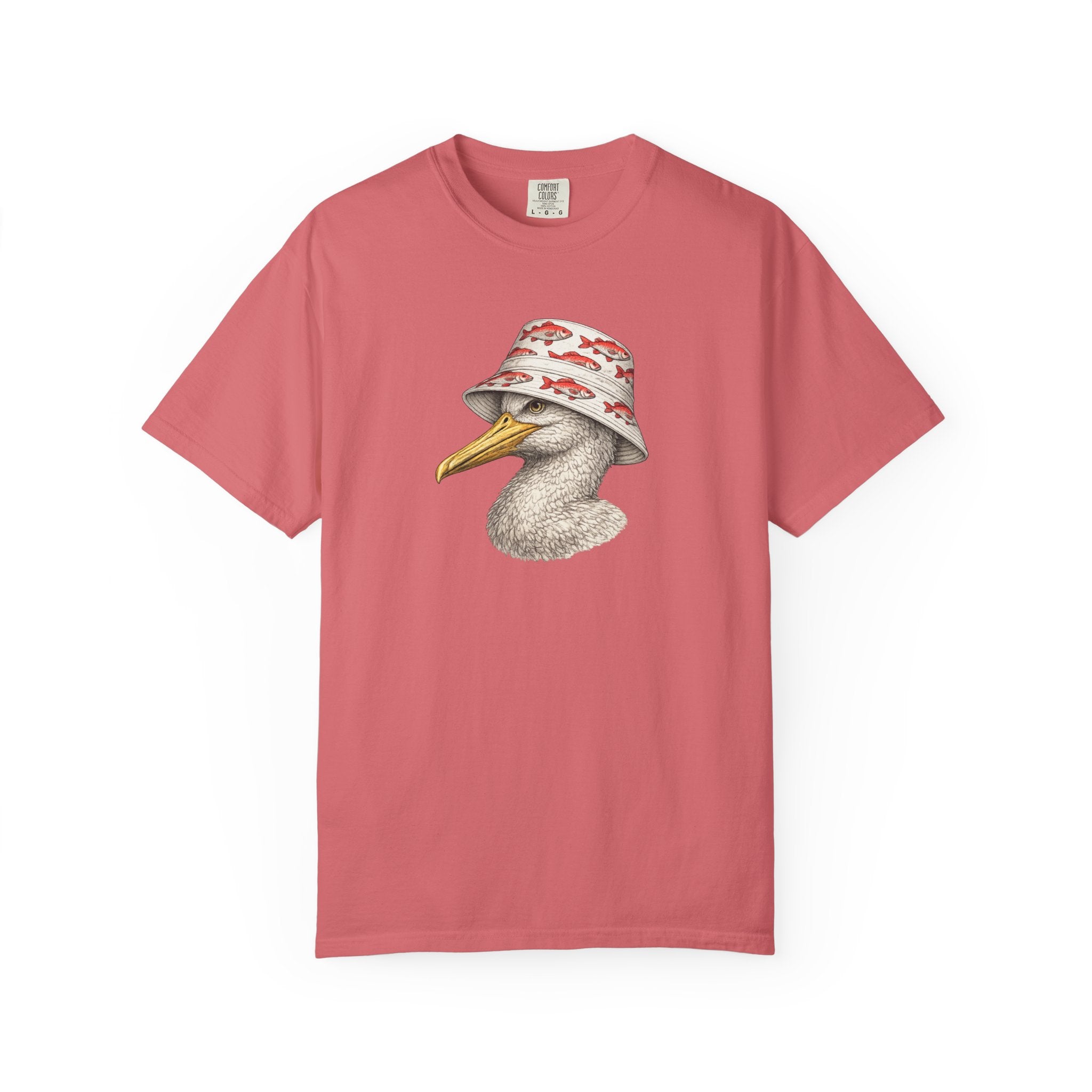 A dusty rose pink short-sleeve t-shirt featuring a graphic print of a white duck with a yellow beak wearing a white bucket hat with red fish patterns, displayed against a solid white background.