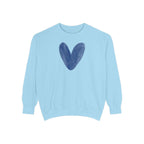 A light blue crewneck sweatshirt featuring a dark blue watercolor heart graphic on the chest, displayed against a solid white background.