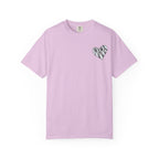 A light pink short-sleeve crewneck t-shirt with a small black heart graphic on the left chest containing the word 'MAMA' in a scribbled font, displayed on a clean white background.