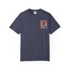 A navy blue short-sleeve crewneck t-shirt with a colorful graphic on the left chest reading 'IN MY BAG MOM ERA' in stacked letters, displayed on a clean white background.