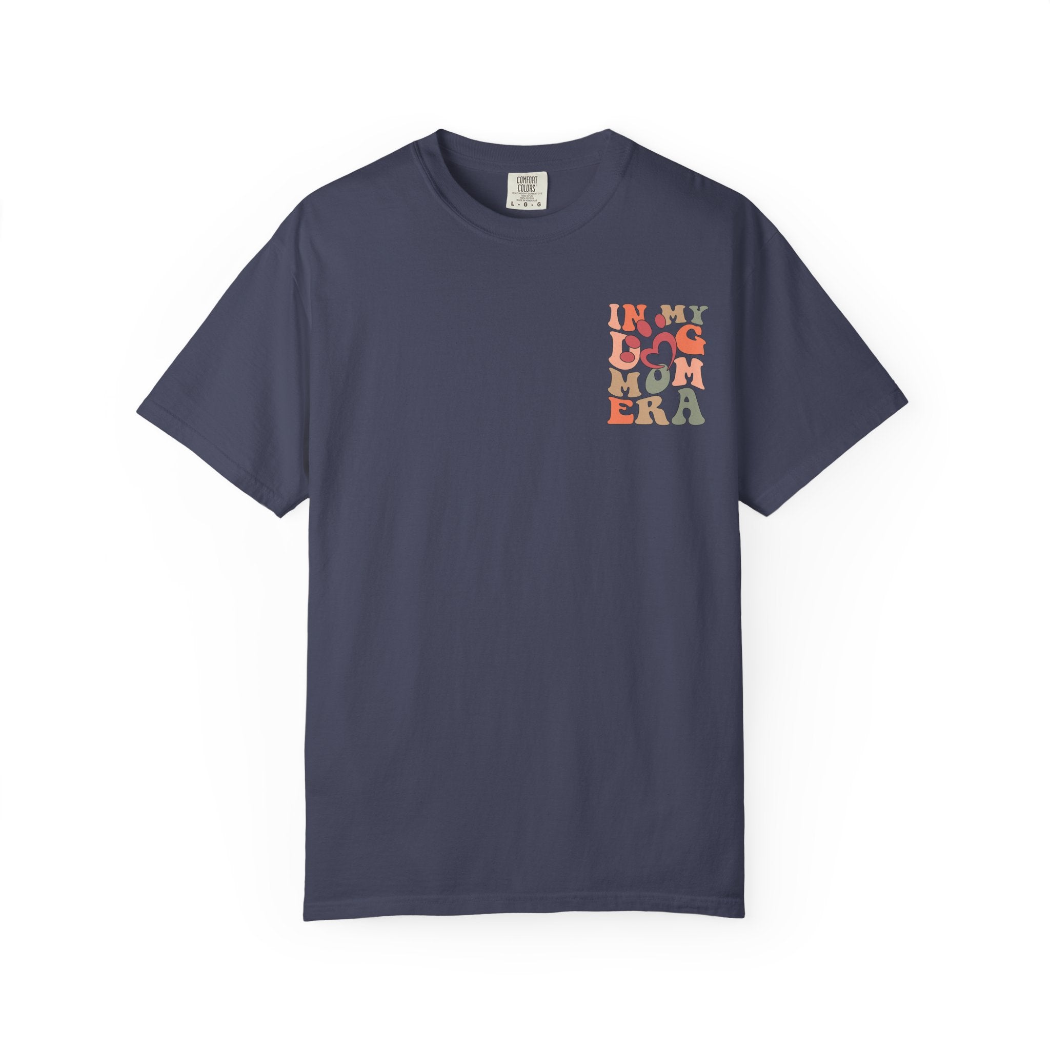 A navy blue short-sleeve crewneck t-shirt with a colorful graphic on the left chest reading 'IN MY BAG MOM ERA' in stacked letters, displayed on a clean white background.