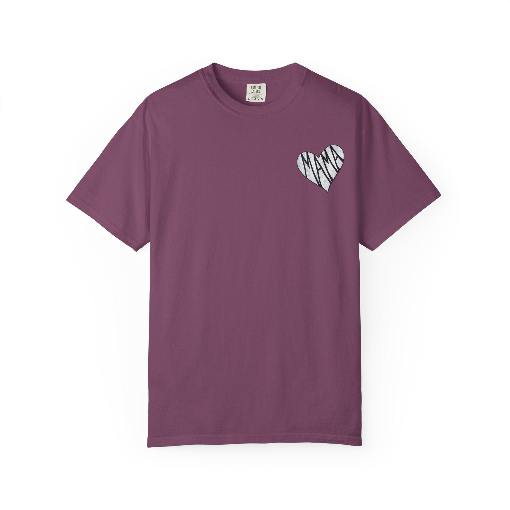 A short-sleeve crewneck t-shirt in a dusty plum purple color, featuring a small white heart graphic on the left chest with the word 'MAMA' written inside in a black-and-white pattern.