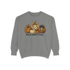 A gray crewneck sweatshirt featuring a graphic of patterned pumpkins and the text 'WILD ABOUT FALL' printed on the chest, displayed against a solid white background.