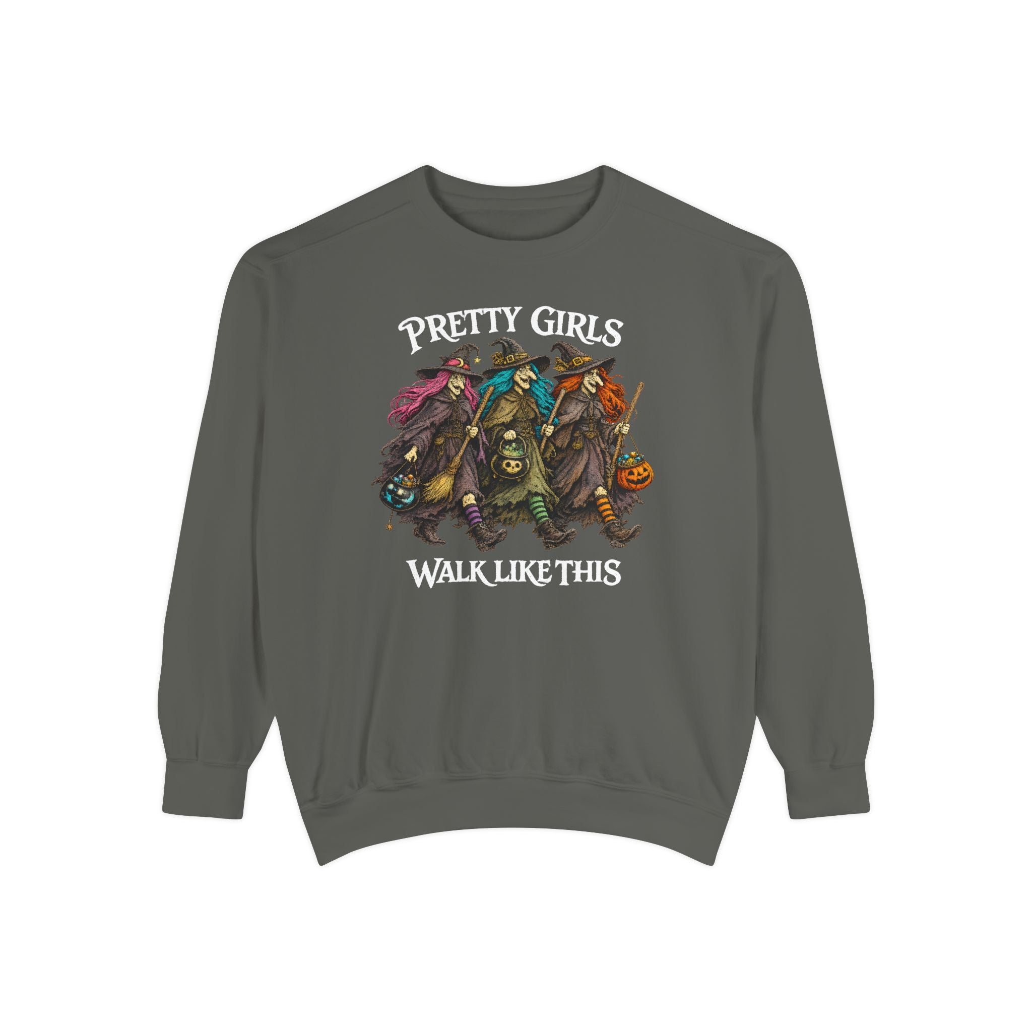 A dark gray crewneck sweatshirt featuring a graphic of four stylized witches riding a pumpkin cart, with the text 'PRETTY GIRLS WALK LIKE THIS' printed in white above and below the illustration.