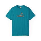 Teal t-shirt with a graphic of a fish tail emerging from water on a white background