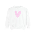 A white crewneck sweatshirt with a large, soft pink heart graphic printed on the center chest, displayed against a solid white background.
