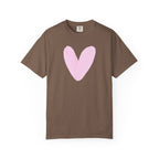 A brown short-sleeve crewneck t-shirt featuring a large, hand-drawn light pink heart on the chest, displayed against a solid white background.