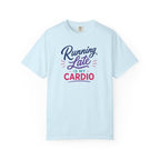 A light blue short-sleeve crewneck t-shirt with a graphic text print reading 'Running Late IS MY CARDIO' in purple, navy, and red lettering, displayed on a clean white background.
