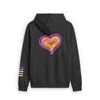 A black pullover hoodie shown from the back, featuring a large, colorful, layered heart graphic in purple, yellow, orange, and pink. The left sleeve has three horizontal stripes in purple, yellow, and black, and there is a small red graphic on the right sleeve.