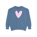 A dusty blue crewneck sweatshirt featuring a large, hand-drawn light pink heart on the chest, displayed against a solid white background.
