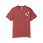 A dusty rose red short-sleeve crewneck t-shirt featuring a small black and white patterned heart on the left chest, displayed against a solid white background.
