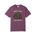 A purple short-sleeve crewneck t-shirt featuring a graphic of four girls dressed as witches with pumpkins, with the text 'PRETTY GIRLS WALK LIKE THIS' printed in white above and below the illustration.