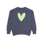 A dark slate blue crewneck sweatshirt featuring a light green watercolor heart printed on the chest, displayed against a solid white background.