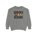 A gray crewneck sweatshirt featuring a 'Spooky Season' graphic on the chest with three cartoon ghosts wearing orange and black plaid, leopard print, and green plaid hats.