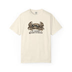 An off-white short-sleeve crewneck t-shirt featuring a graphic of a crab and the text 'IF CRABBY, RETURN TO BEACH' printed on the chest.