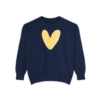 A navy blue crewneck sweatshirt featuring a large, textured yellow heart graphic printed on the center chest, displayed against a solid white background.