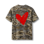 A short-sleeve crewneck t-shirt featuring a classic camouflage pattern in shades of brown, beige, and gray, with a large, bold red hand-painted style heart on the back.