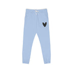Light blue sweatpants with a small black heart graphic on the upper left leg and a white drawstring at the elastic waistband, shown flat on a white background.