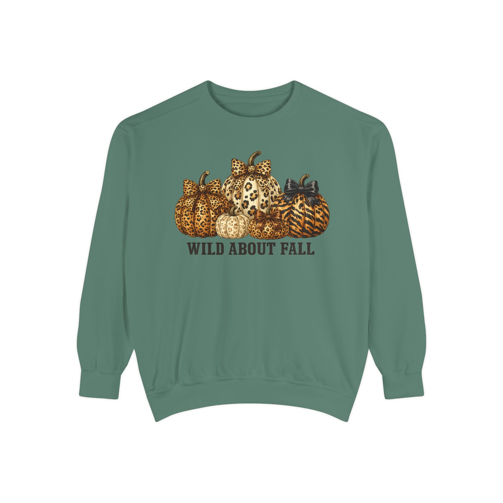 A sage green crewneck sweatshirt featuring a graphic of patterned pumpkins and the text 'WILD ABOUT FALL' printed on the chest, displayed against a solid white background.