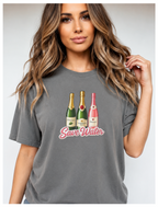 Woman wearing a gray t-shirt with graphic designs and text