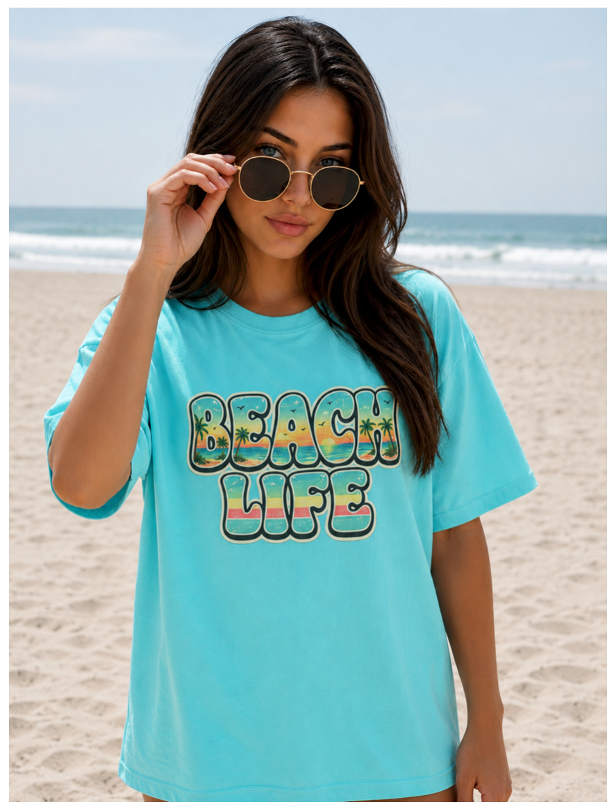 Woman wearing a blue 'Beach Life' t-shirt on a beach.