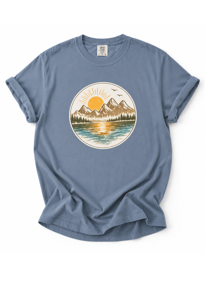 Blue t-shirt with a nature graphic on a white background
