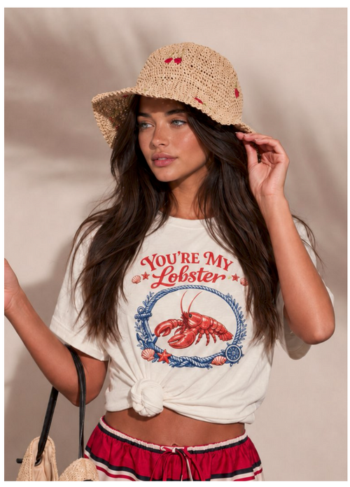 Woman wearing a 'You're My Lobster' t-shirt and straw hat against a neutral background