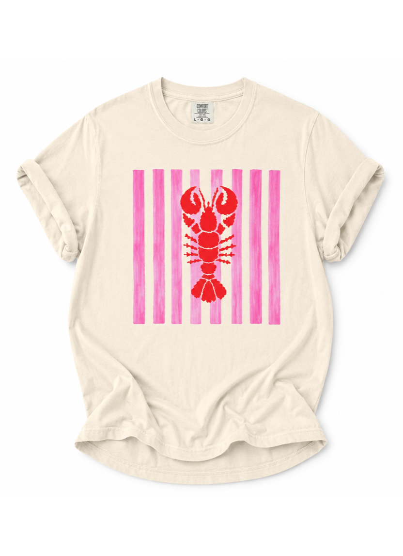 Beige t-shirt with a red lobster on pink and white striped background