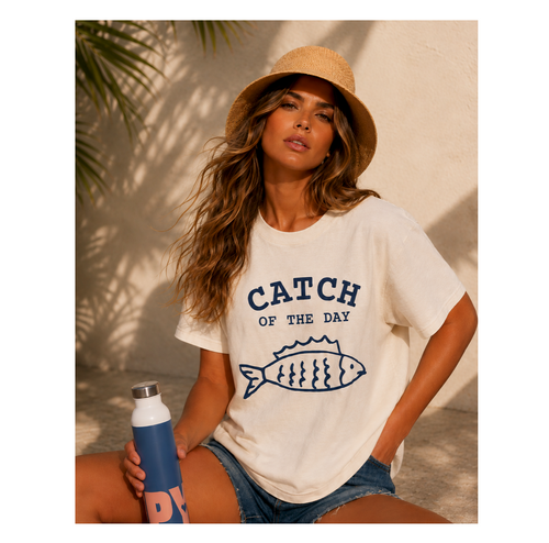 Woman wearing a 'Catch of the Day' t-shirt on a beach