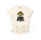 Beige t-shirt with a graphic of a bear wearing a hat on a white background