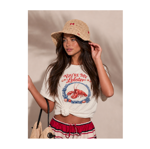 Woman wearing a 'You're My Lobster' t-shirt and straw hat against a beige background