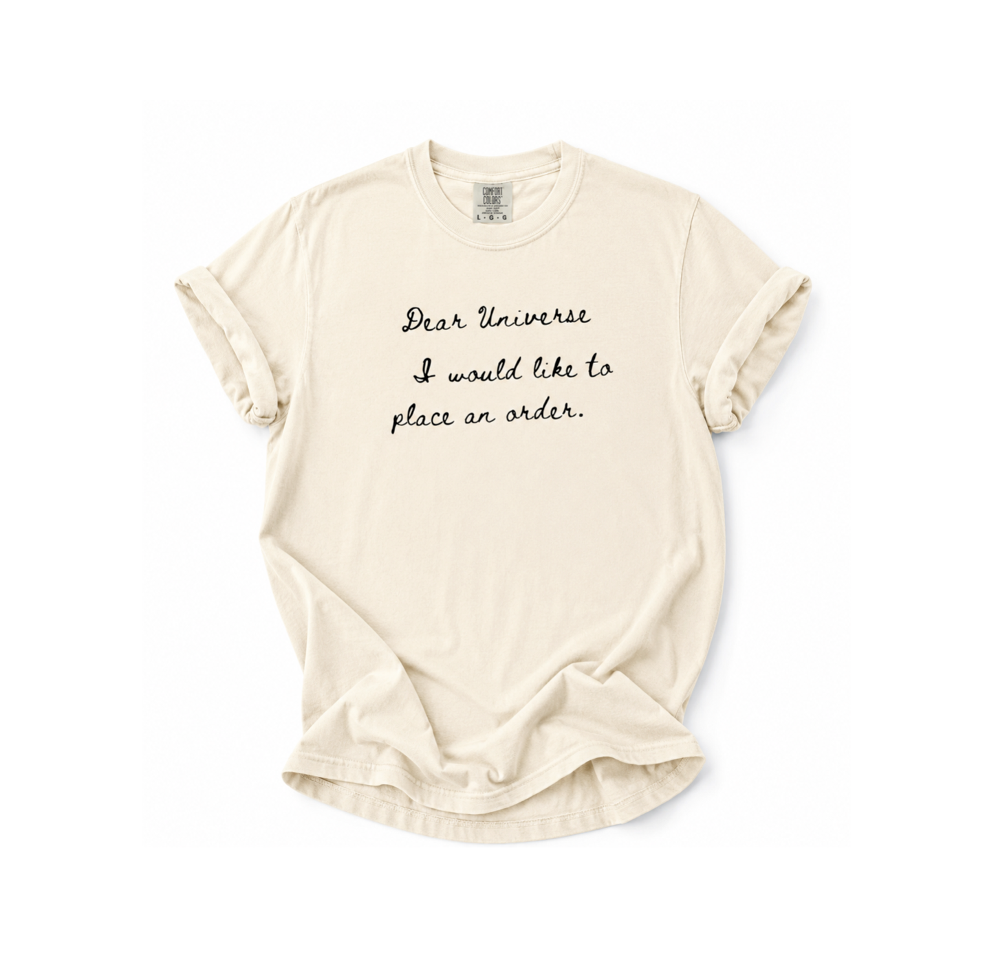 Beige t-shirt with text 'Dear Universe I would like to place an order' on a white background