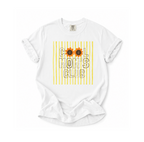 A white short-sleeve t-shirt with a graphic print reading 'COOL MOM'S CLUB' in black outlined letters over yellow vertical stripes, with two sunflower graphics replacing the O's. The shirt is laid flat on a white background.